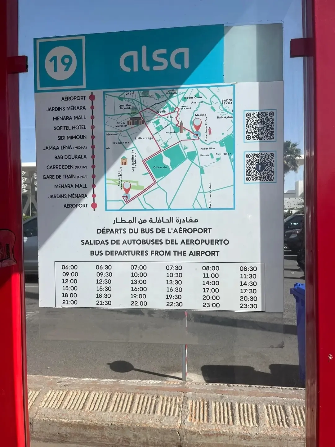 Marrakech Airport Bus Line 19 information board showing route map, schedule, and departure times from 6:00 AM to 11:30 PM for transportation between airport and city center.
