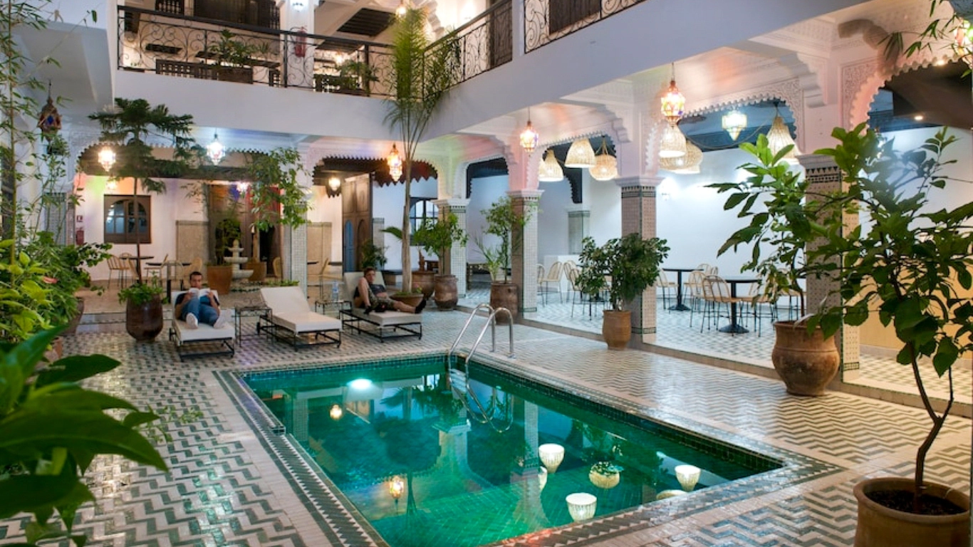 Traditional Moroccan riad with indoor pool and lounge area at The Central House Marrakech Medina