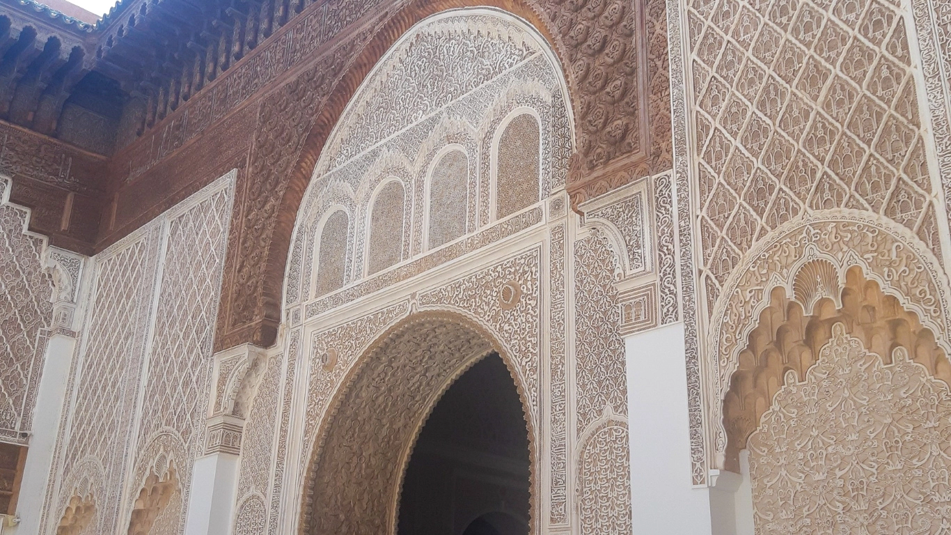 Detailed facade and traditional Moroccan stucco artistry at Ben Youssef Madrasa, one of Marrakech’s top historical sites.
