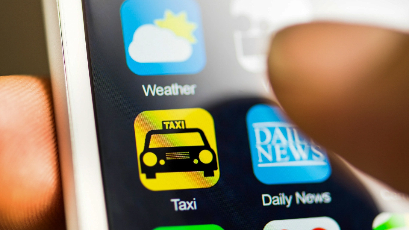 Ride-hailing app icon on a smartphone, representing convenient and affordable transportation options in Marrakech.