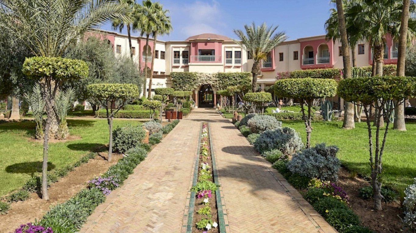 Luxurious Moroccan-style lobby with intricate white arches and central fountain at iberostar waves club palmeraie Marrakech - all inclusive