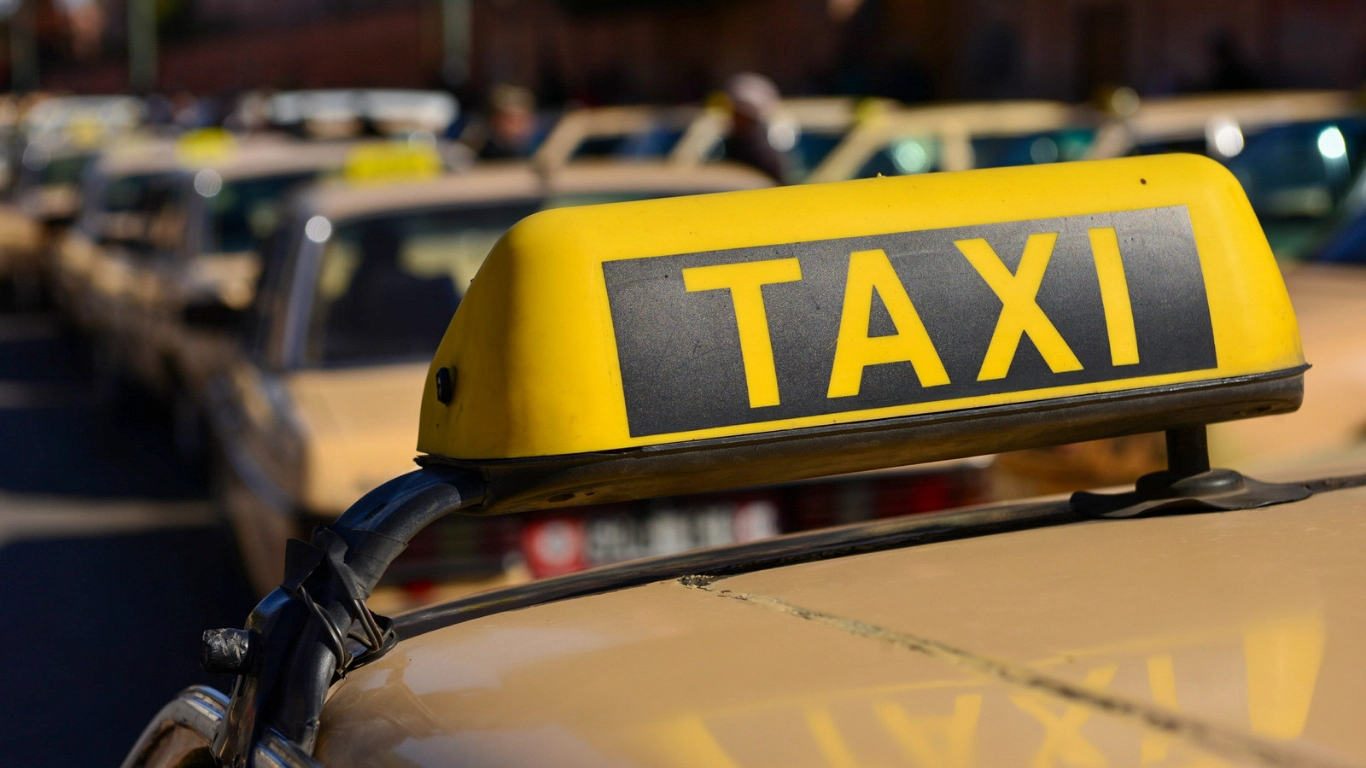 Yellow taxi sign in Marrakech – transportation option from Marrakech airport to the city center
