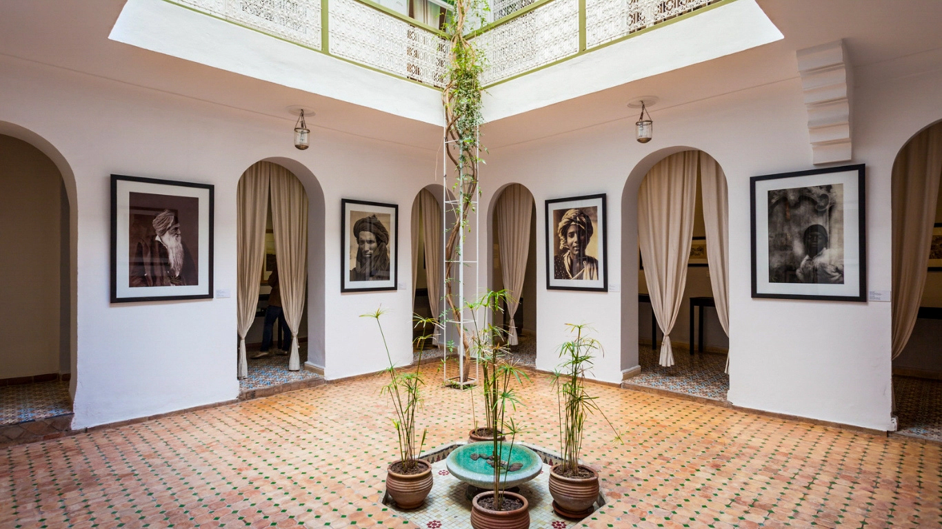 nterior view of the Museum of Photography in Marrakech, featuring black and white portraits and a central courtyard