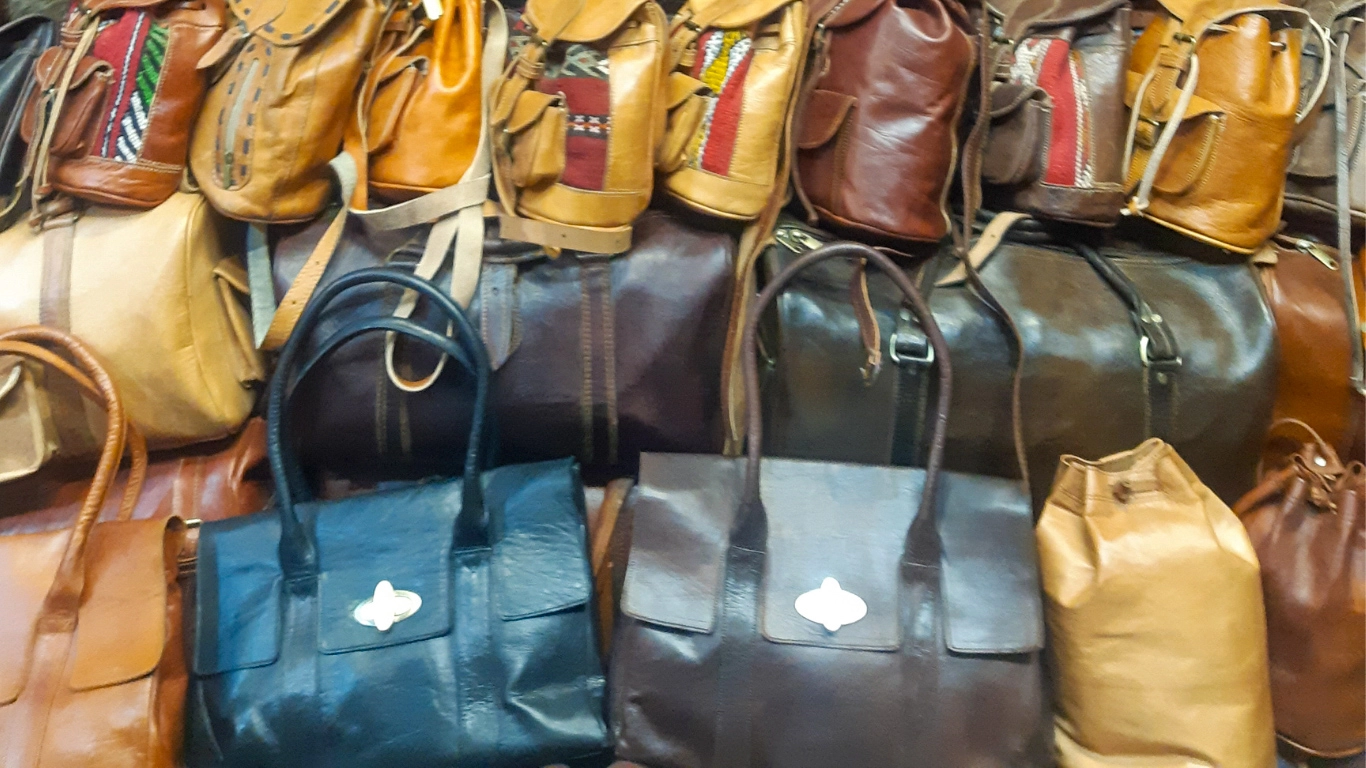 Colorful leather bags and accessories displayed in a Marrakech market - what to buy in Marrakech