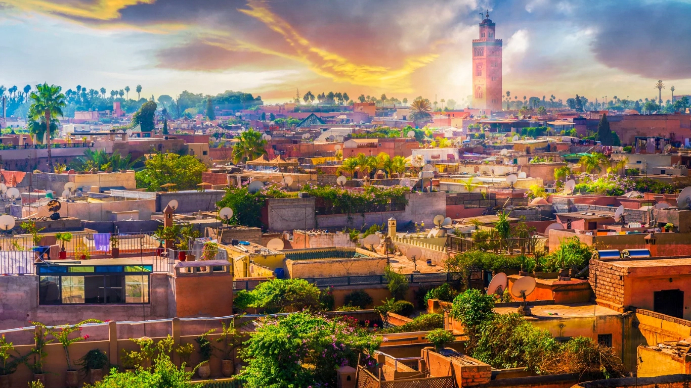 Winter sunset in Marrakech during December, featuring a cloudy sky and cool weather with the Koutoubia Mosque in the skyline.